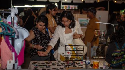Attendees viewing products at vendor booth