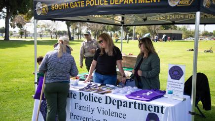 South Gate Police Dept. booth staffers sharing information with attendee