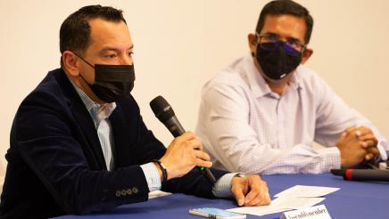 Speaker Rendon wearing mask and speaking at microphone