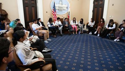 Speaker Rendon and students seated in a circle