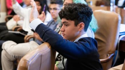 Student with question raising hand