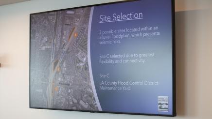 TV displaying map of future center's site