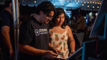 Close-up of attendees viewing products at vendor booth