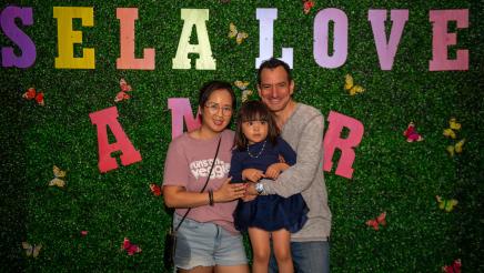 Speaker Emeritus Rendon with family in front of "SELA Love Amor" photo background