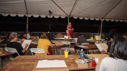 Live model poses while attendees use sketch pads