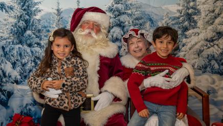 Kids posing with Mr. and Mrs. Claus