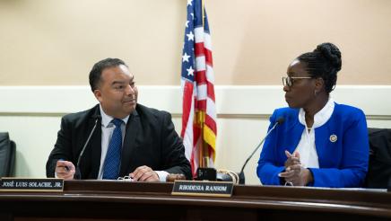 Asm. Solache conversing with Asm. Ransom, both seated at long desk