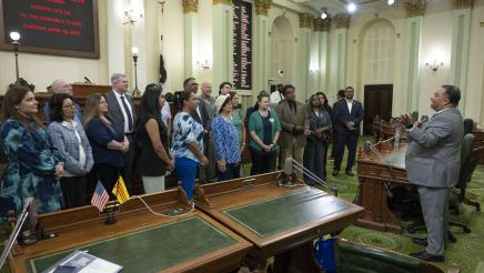 Asm. Solache speaking to Donate Life California representatives and gesturing with hands