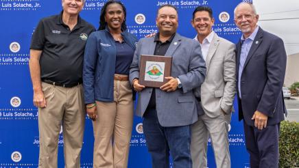 Asm. Solache presenting honorees with an award