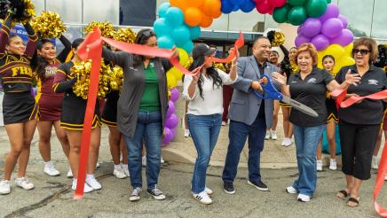 Asm. Solache cutting ceremonial ribbon with large scissors
