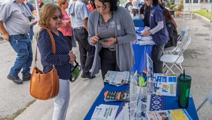 Informational booth staffers assisting constituents