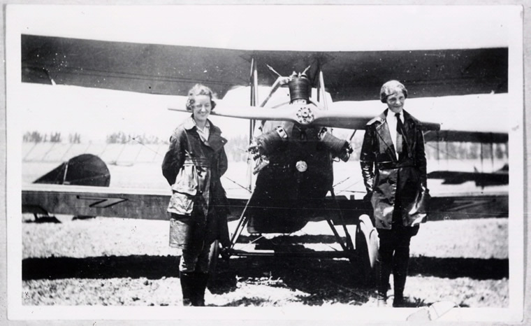 Amelia and Anita standing in front of plane